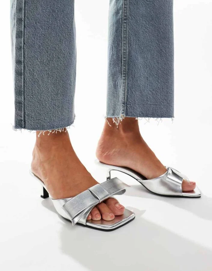 ASOS DESIGN Hyphen bow detail mid heeled mules in silver