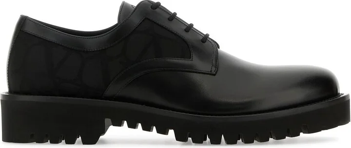 Black leather and Tolie Iconographe lace-up shoes