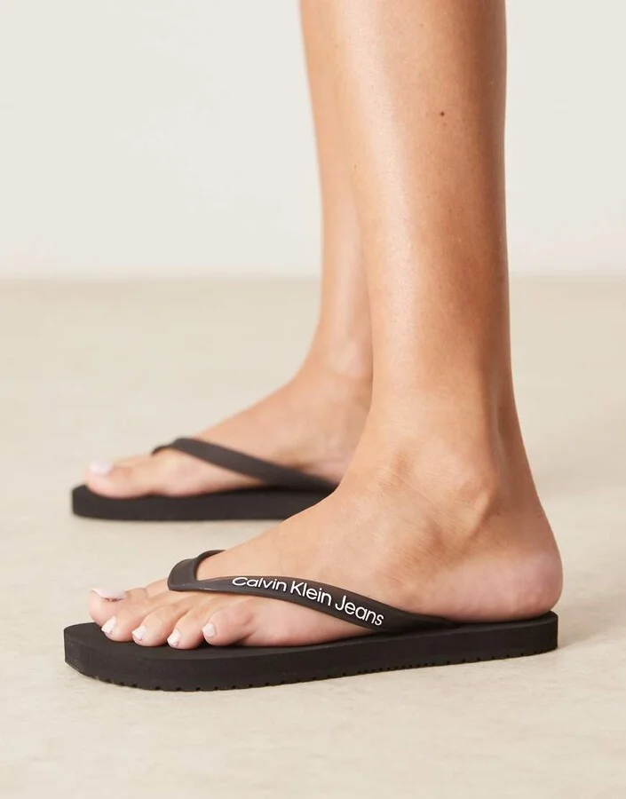 Calvin Klein Jeans logo flip flops in black