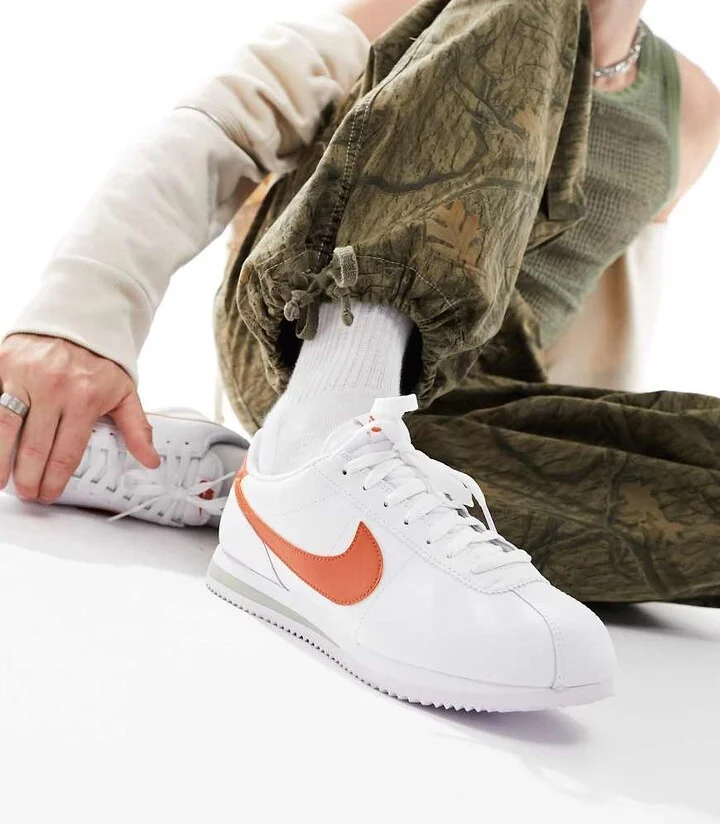 Nike Cortez leather sneakers in white and orange